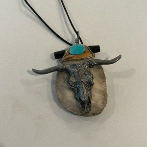Unusual, pendant necklace neutral colors highlighted with turquoise
